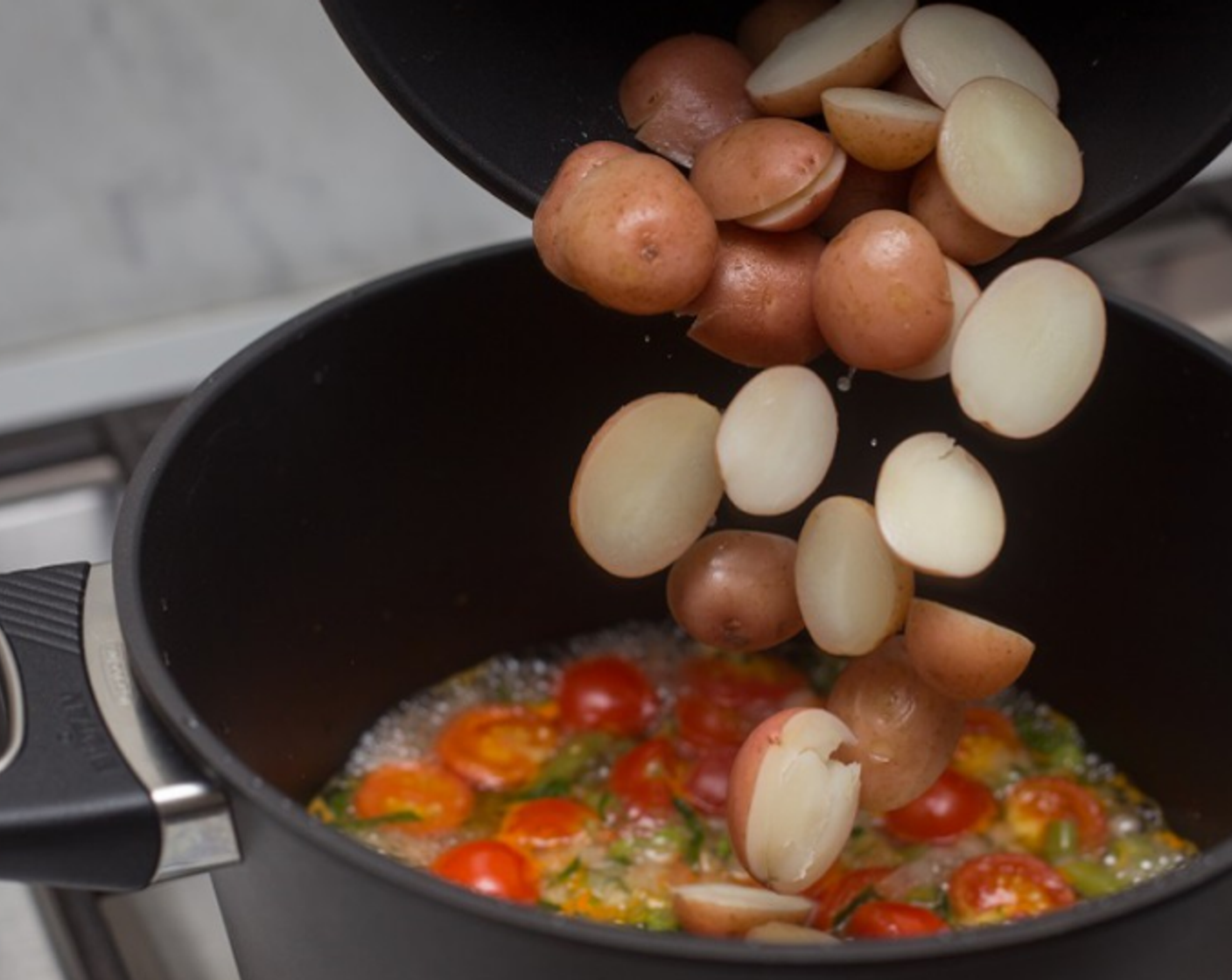 step 8 When potatoes finish cooking, drain liquid away, and add potatoes to bean pot.