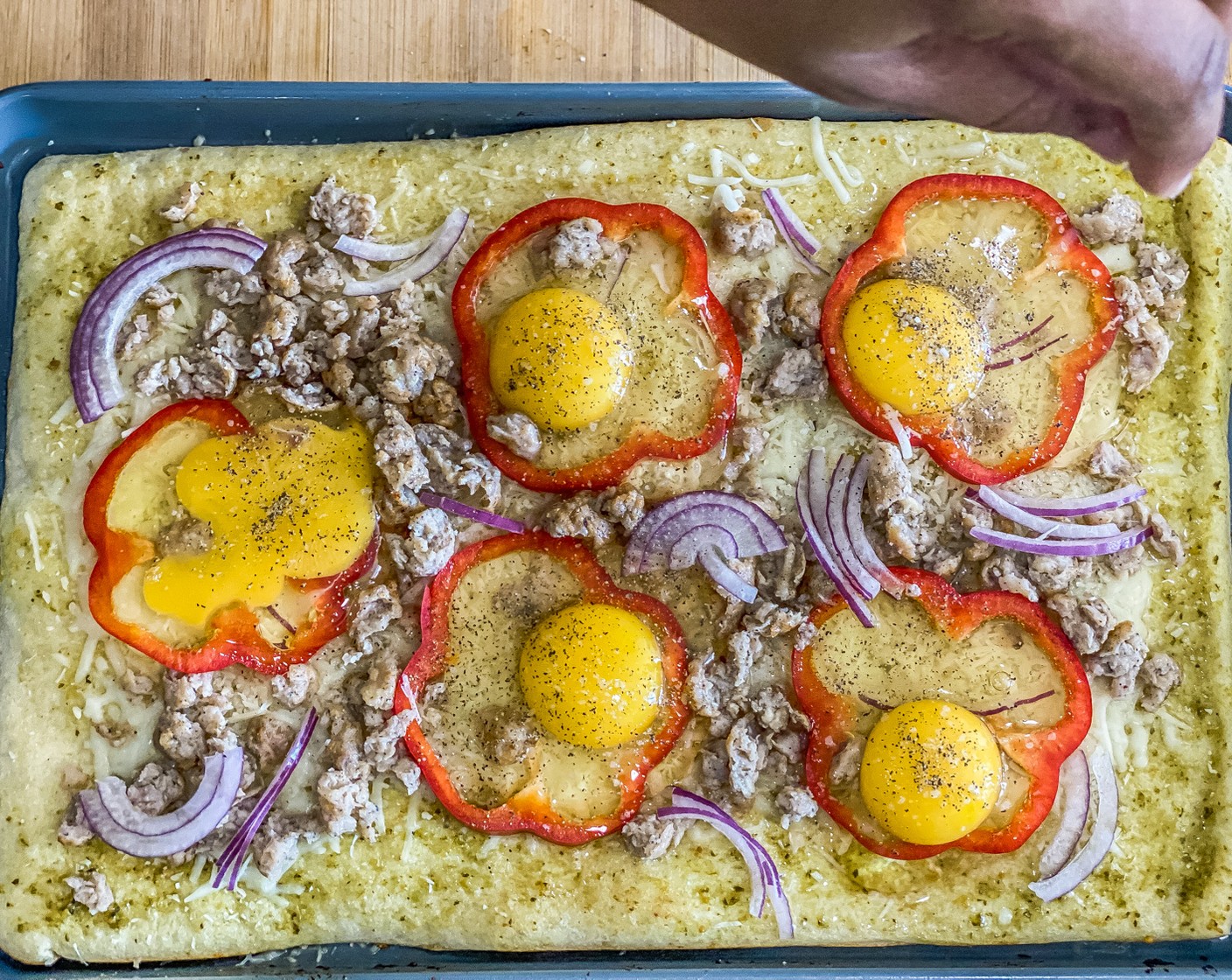 step 8 Sprinkle each egg with Kosher Salt (1/4 tsp) and Ground Black Pepper (1/4 tsp). Sprinkle remaining cheese and red onion over the top.