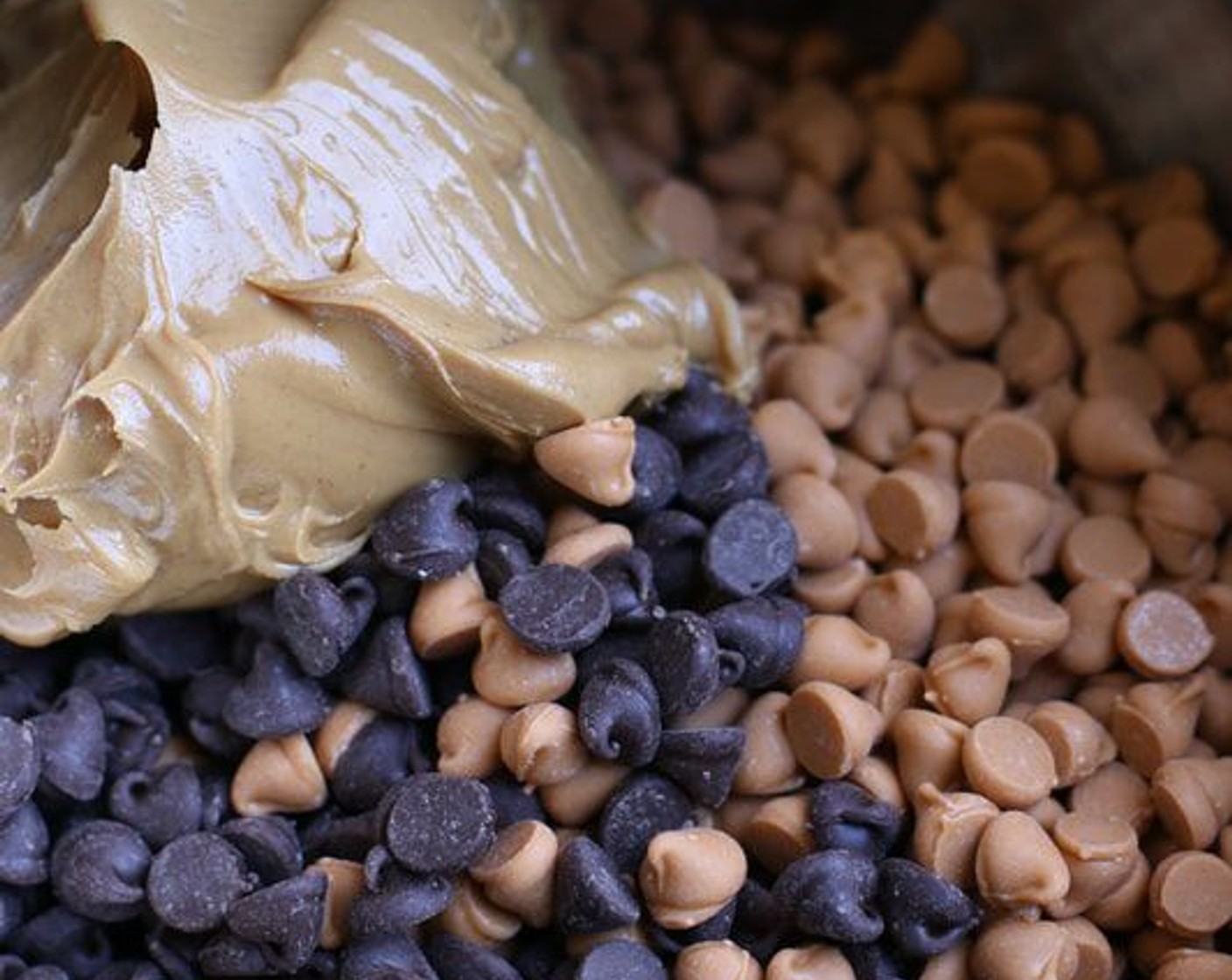 step 2 In the top of a double boiler with at least 1-inch of water simmering in the bottom pan, combine the Creamy Peanut Butter (1 cup), Semi-Sweet Chocolate Chips (1 pckg) and Butterscotch Chips (1 pckg). Don’t be tempted to melt your chips in the microwave – simmering on the top of a double boiler melts the chips at a lower temperature, and easier and more consistently without the fear of the mixture seizing up.