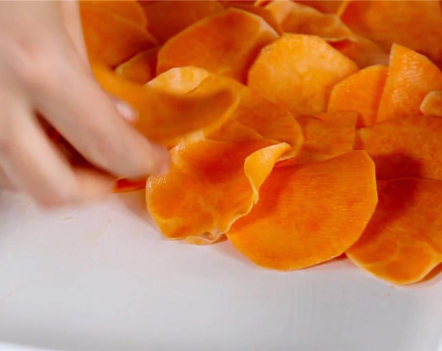 step 7 Start layering the sweet potato rounds into the dish, with one or two layers overlapping and all the rounds tightly together.