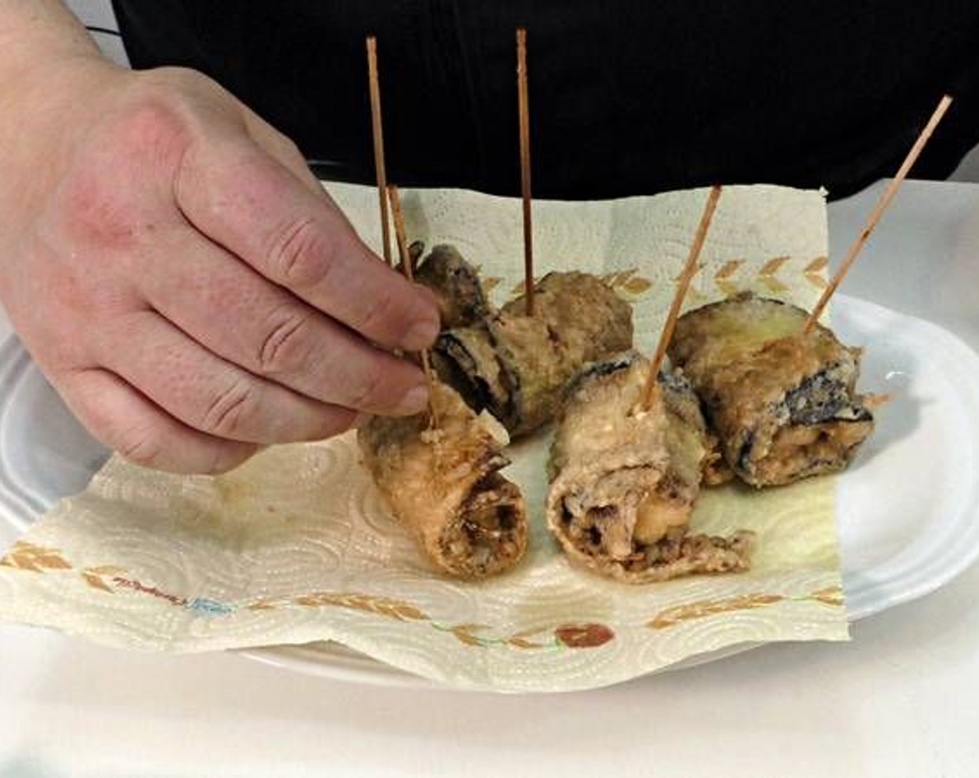 step 6 As they become golden brown in color, remove and place on a plate with paper towel to absorb the excess oil.