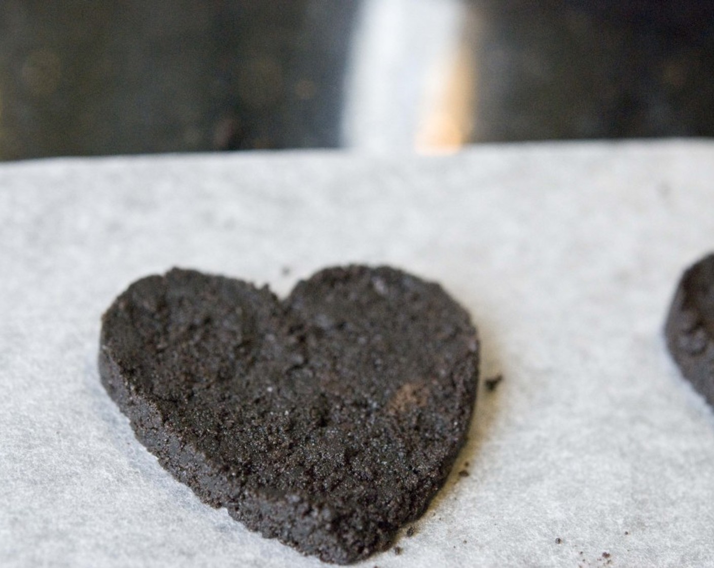 step 7 Gently remove the cookie cutter. You’ll have nice heart-shaped Oreos. Make 3 more using the remaining crumble, we are going to decorate our cheesecake with these hearts. Place the crust and hearts in the refrigerator to chill.