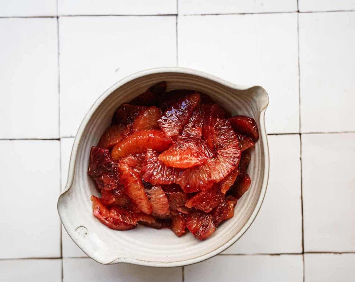 step 1 To a salad bowl begin supreming the Blood Oranges (6) and squeeze each to remove excess juice.