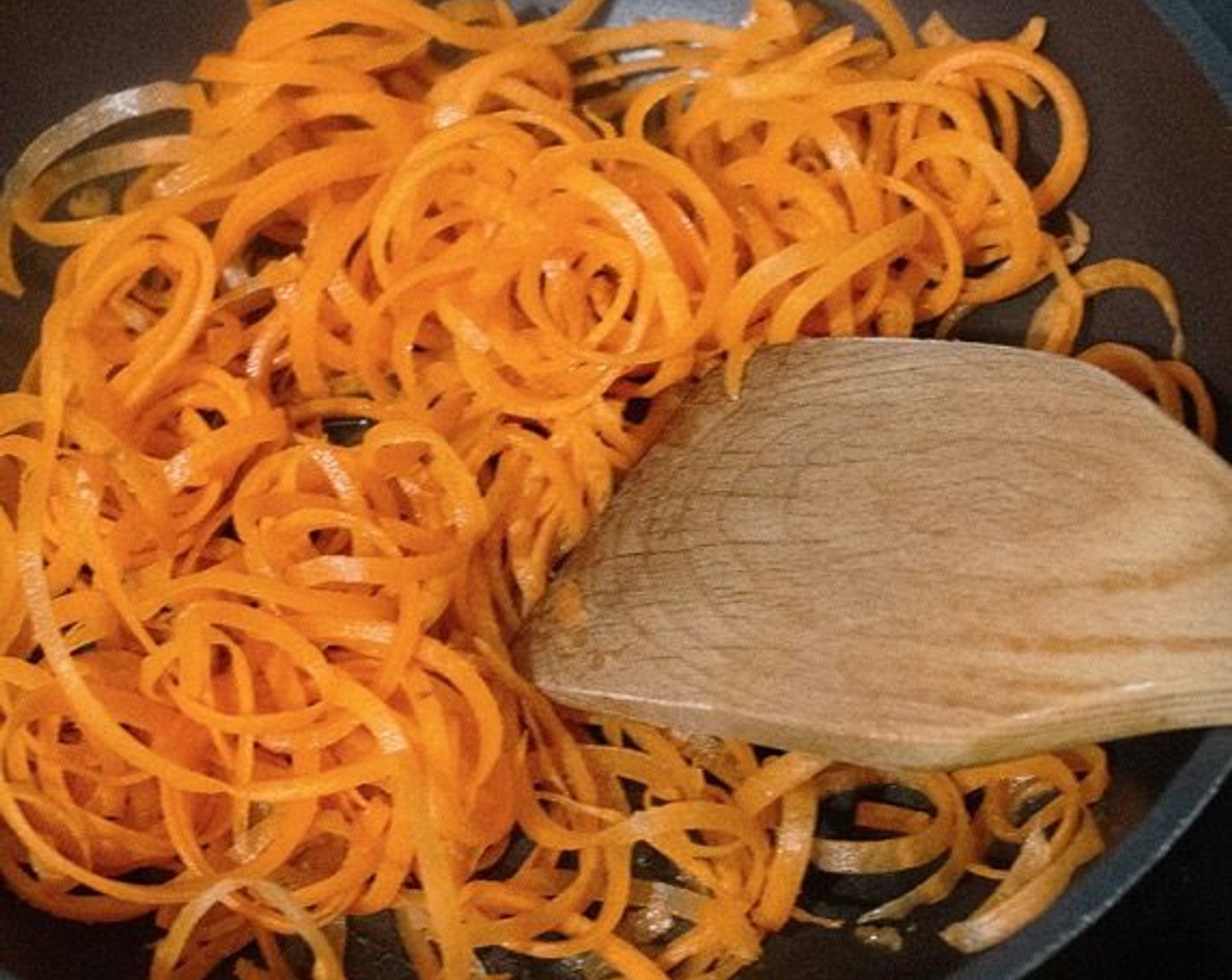 step 1 Heat the Sesame Oil (1 Tbsp) in a frying pan over medium-low heat. Add the Carrots (2) and stir-fry until they just start to color.