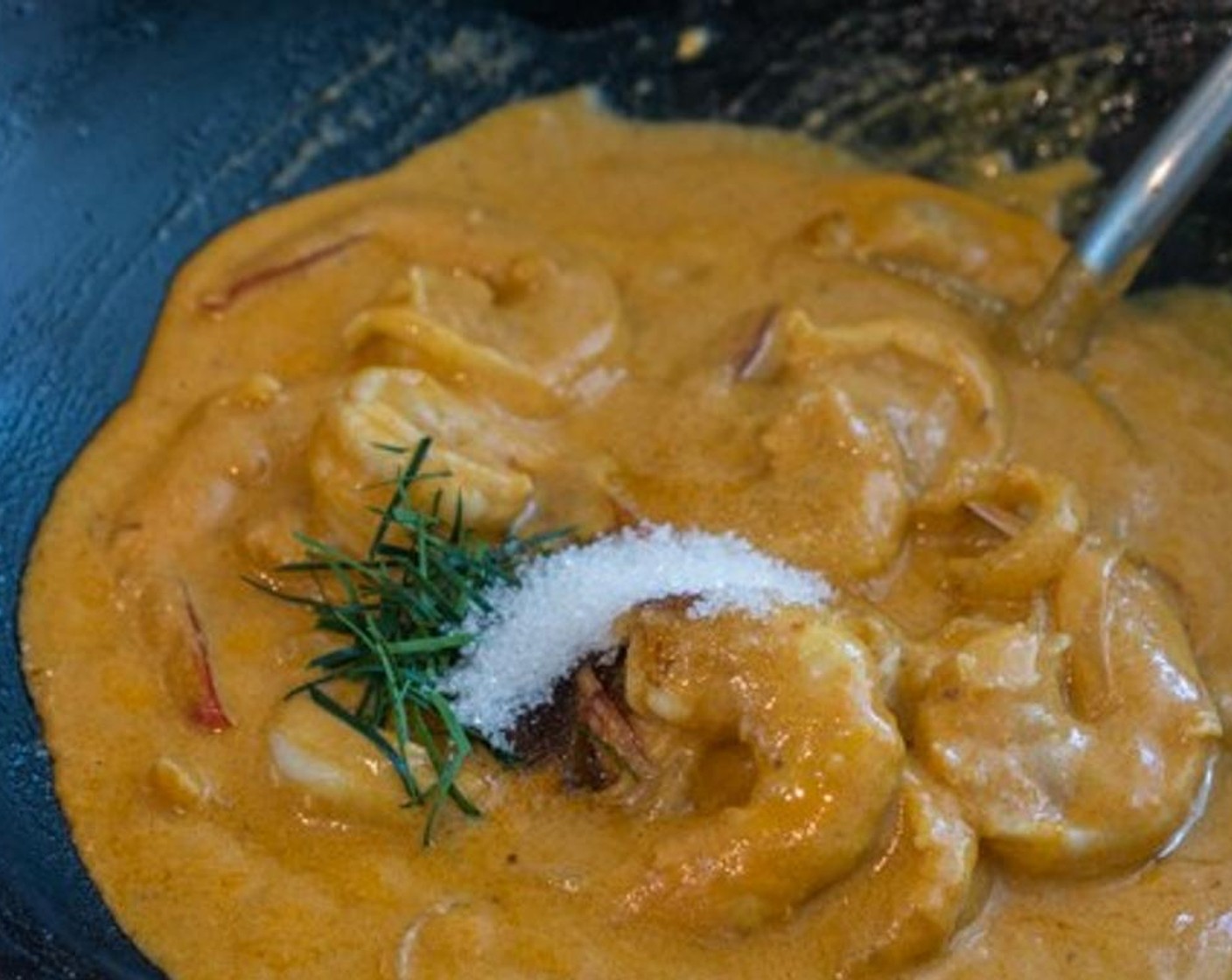 step 6 When all of the shrimp are cooked, add Granulated Sugar (1 Tbsp), Fish Sauce (1 tsp), half of the Kaffir Lime Leaves (3).