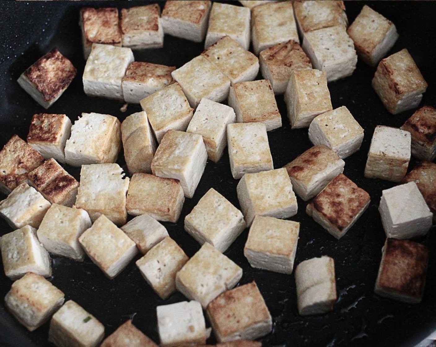 step 1 Heat the Vegetable Oil (1 Tbsp) in a large, non-stick pan, add the Firm Tofu (14 oz) and fry for 4-5 minutes until it turns slightly golden in color.