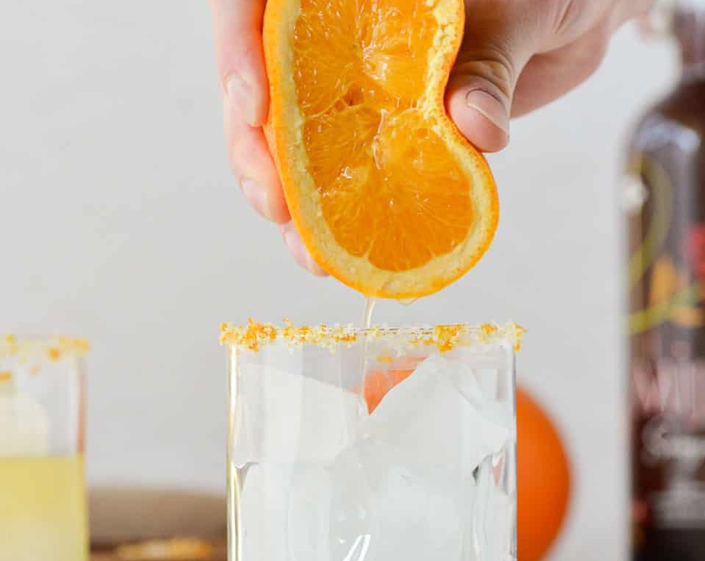 step 1 Squeeze Limes (2) and Orange (1) into a glass filled with ice. Add PATRÓN® Silver Tequila (4 oz). Stir.
