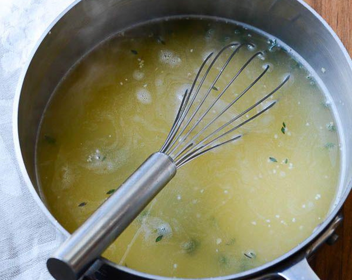 step 5 Meanwhile, in a medium saucepan bring Low-Sodium Chicken Broth (4 cups) and Fresh Thyme (5 sprigs) to a boil.