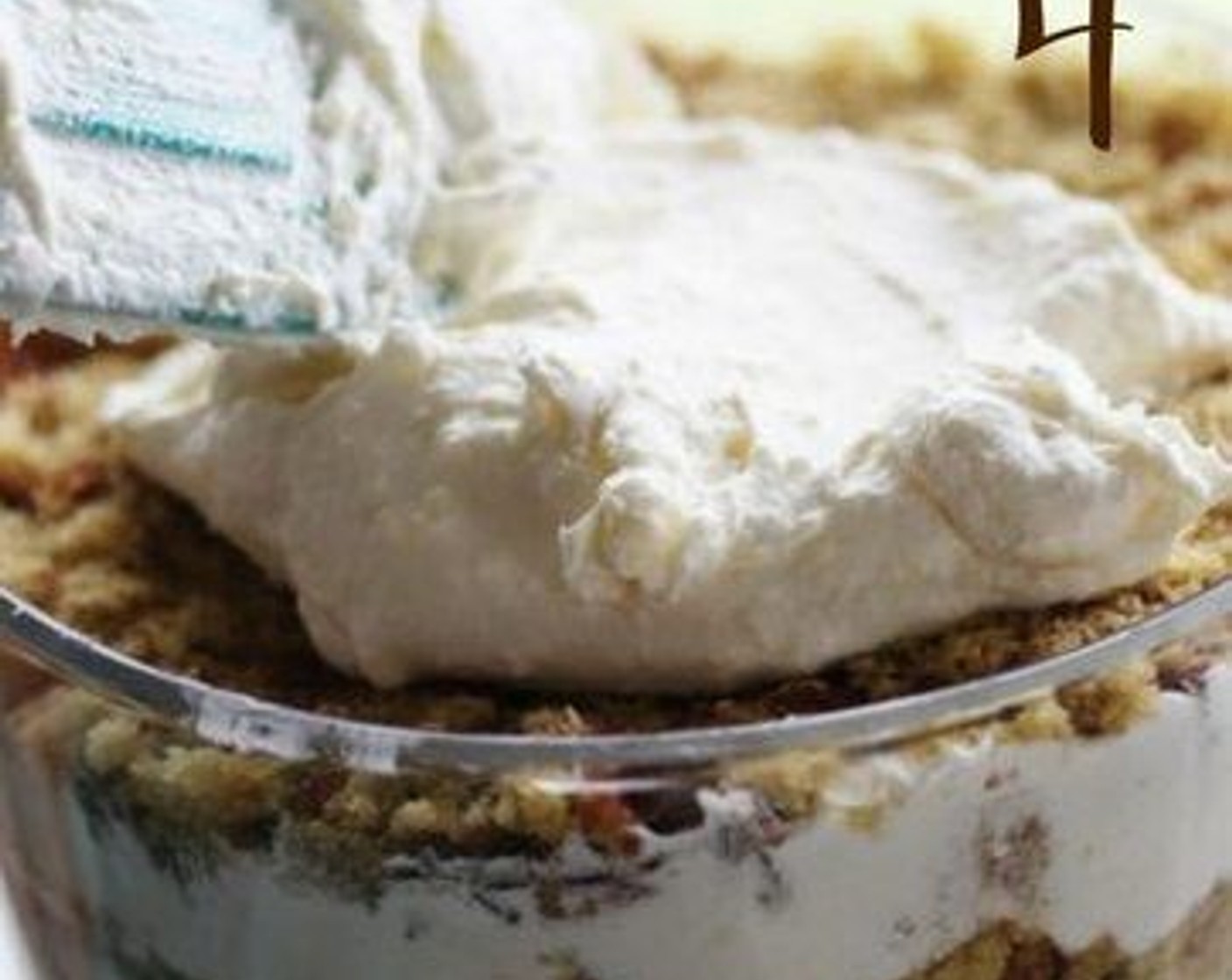 step 6 In a large clear punch bowl or trifle dish, assemble the punch bowl cake in layers. Start with a layer of cake crumbs, then top with the whipped cream mixture, and a layer of crumbled peanut butter cups.