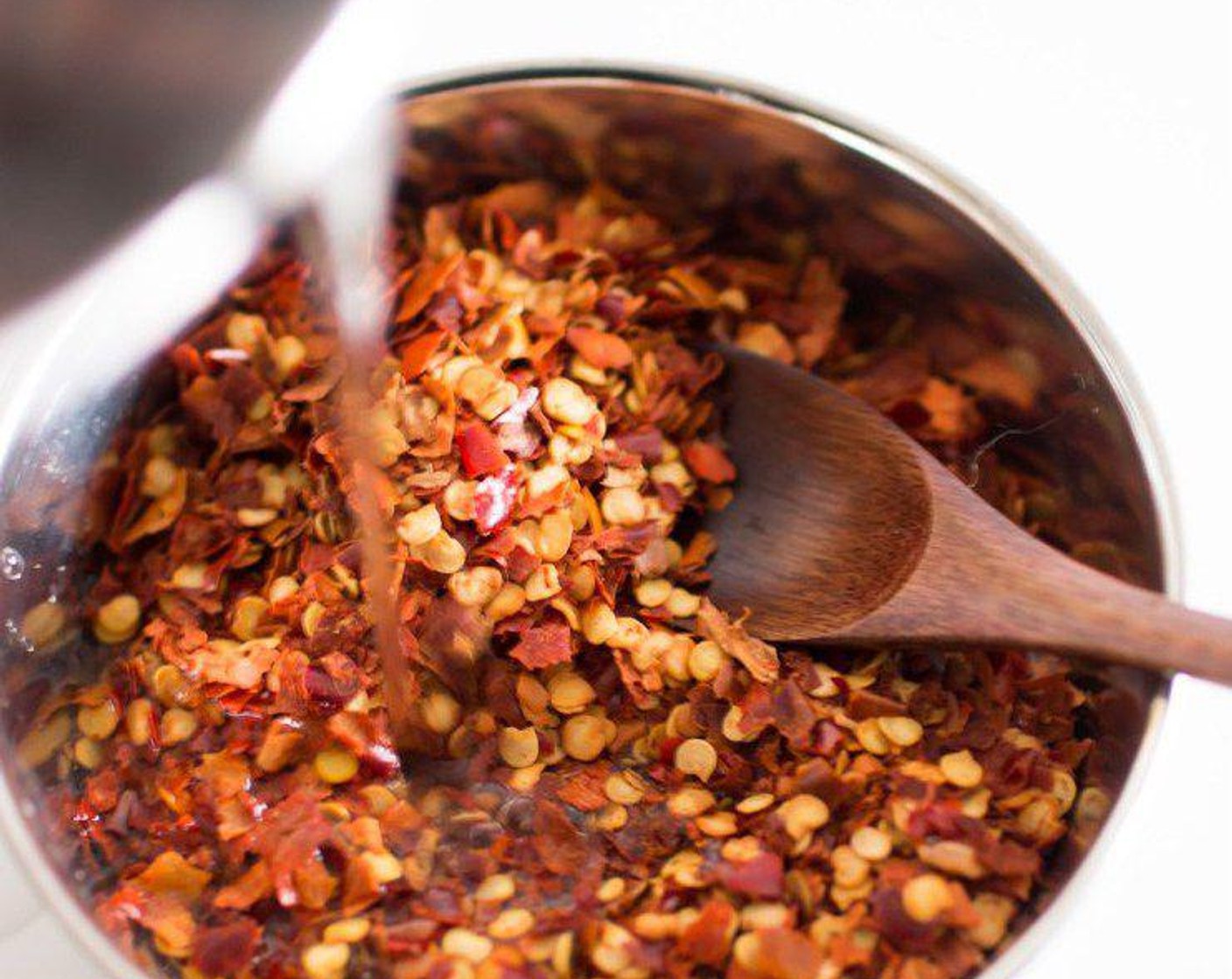 step 1 Add Water (3 Tbsp) to the Crushed Red Pepper Flakes (2/3 cup) and mix well. Set aside, let the chilli flakes soak in the water little bit.