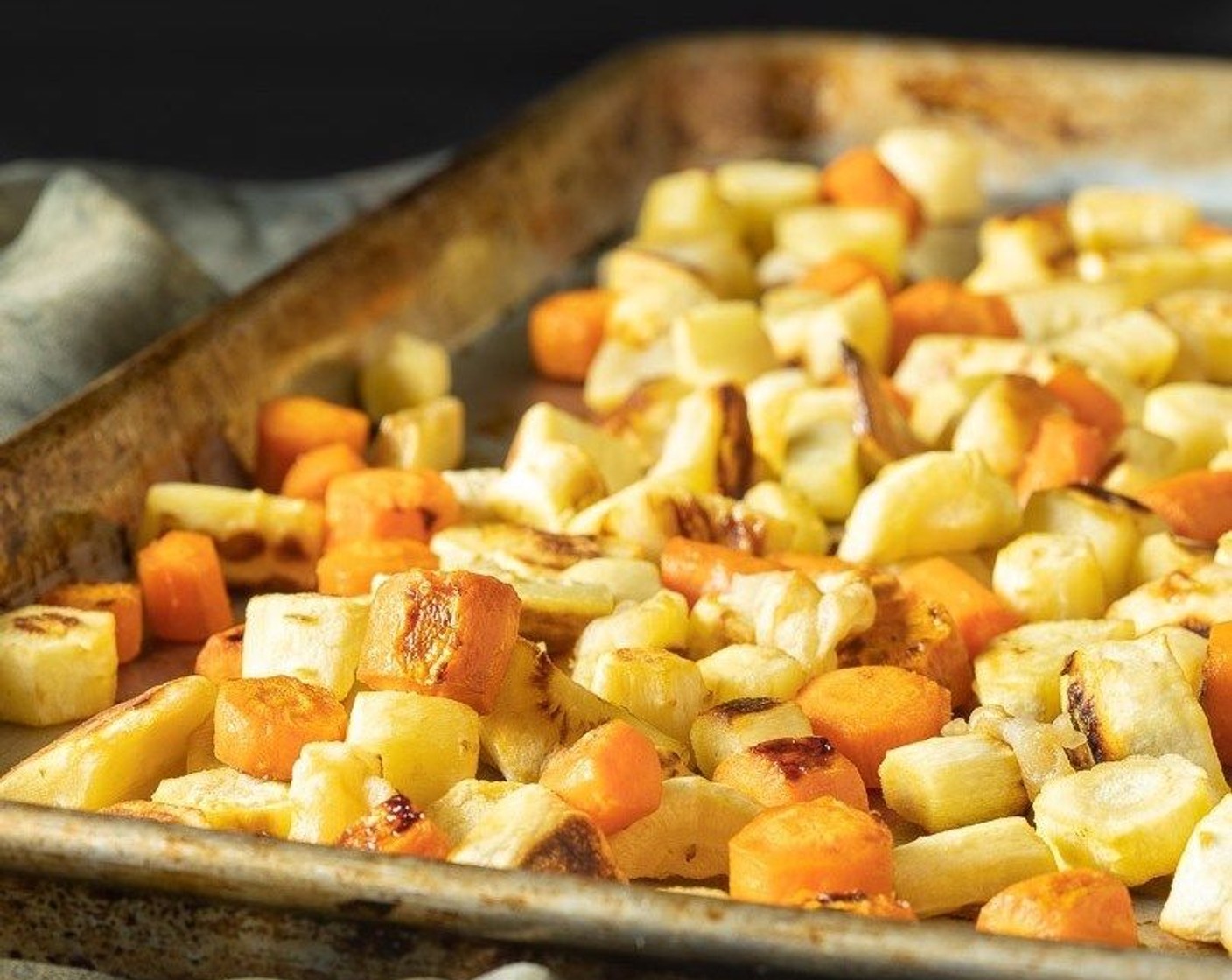 step 2 Toss Parsnips (2 1/2 cups), Carrots (1 1/2 cups), Apple (1) and Garlic (4 cloves) with Olive Oil (1 Tbsp). Spread out on a large baking tray in a single layer. Roast for 40 minutes, flipping once after 20 minutes.