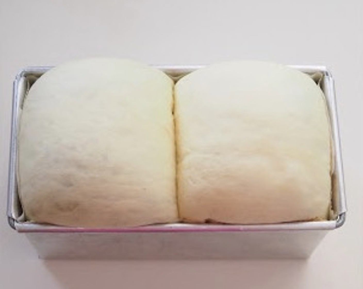 step 9 Place the dough in a loaf pan lined with parchment paper. Let it rise for another 45 minutes to 1 hour, or until double in size.