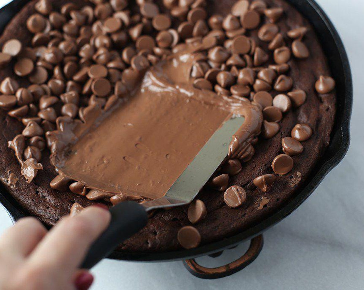 step 7 Remove from the oven and spread the melted chocolate evenly on the brownie.