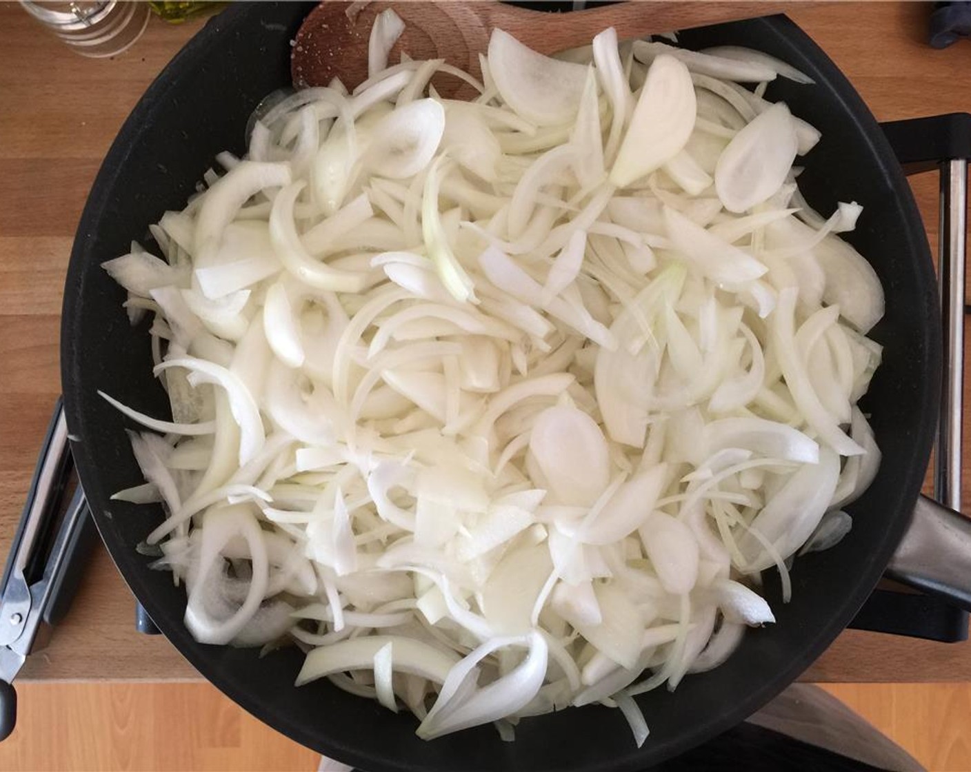 step 5 Place a large frying pan over medium high heat. When hot, add the onions and let them sit so they get some color.