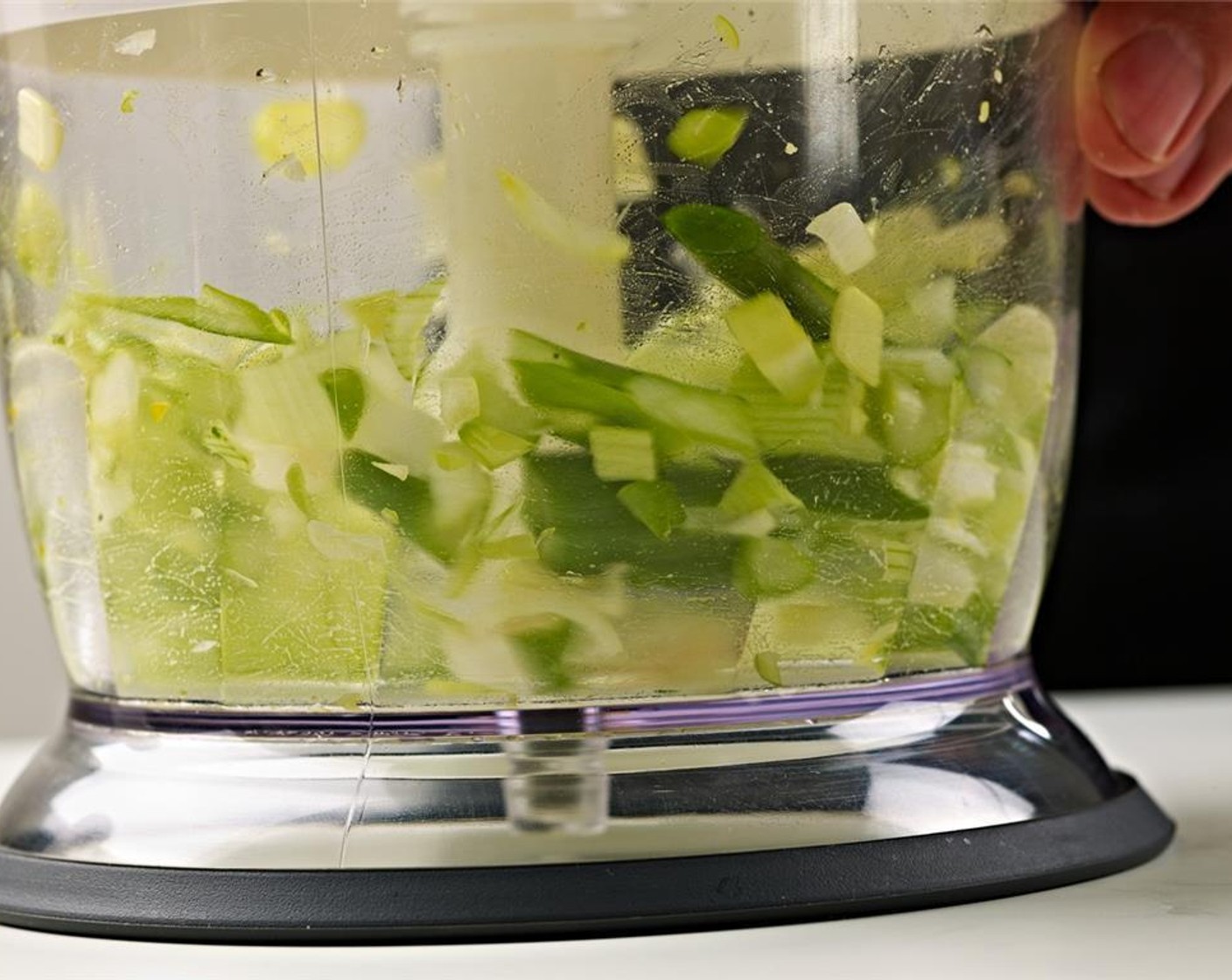 step 2 In a food processor, add peeled Garlic (3 cloves), fresh Fresh Ginger (2 Tbsp), pre-cut lemon grass, Fresh Cilantro (1 bunch), Red Chili Peppers (2), Ground Turmeric (1/2 tsp), and Olive Oil (2 Tbsp).  Blend into a paste and set aside.