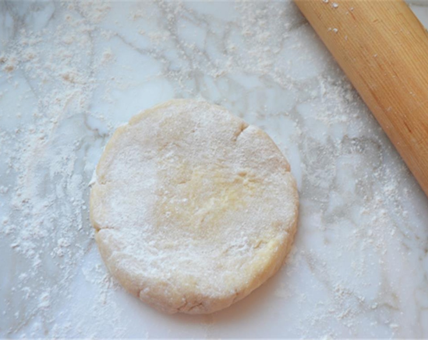 step 5 Remove the dough from the refrigerator. Dust your work surface lightly with flour and sprinkle a little flour over the dough. Use your hands to work the dough into a smooth disc, careful not to over-work it.