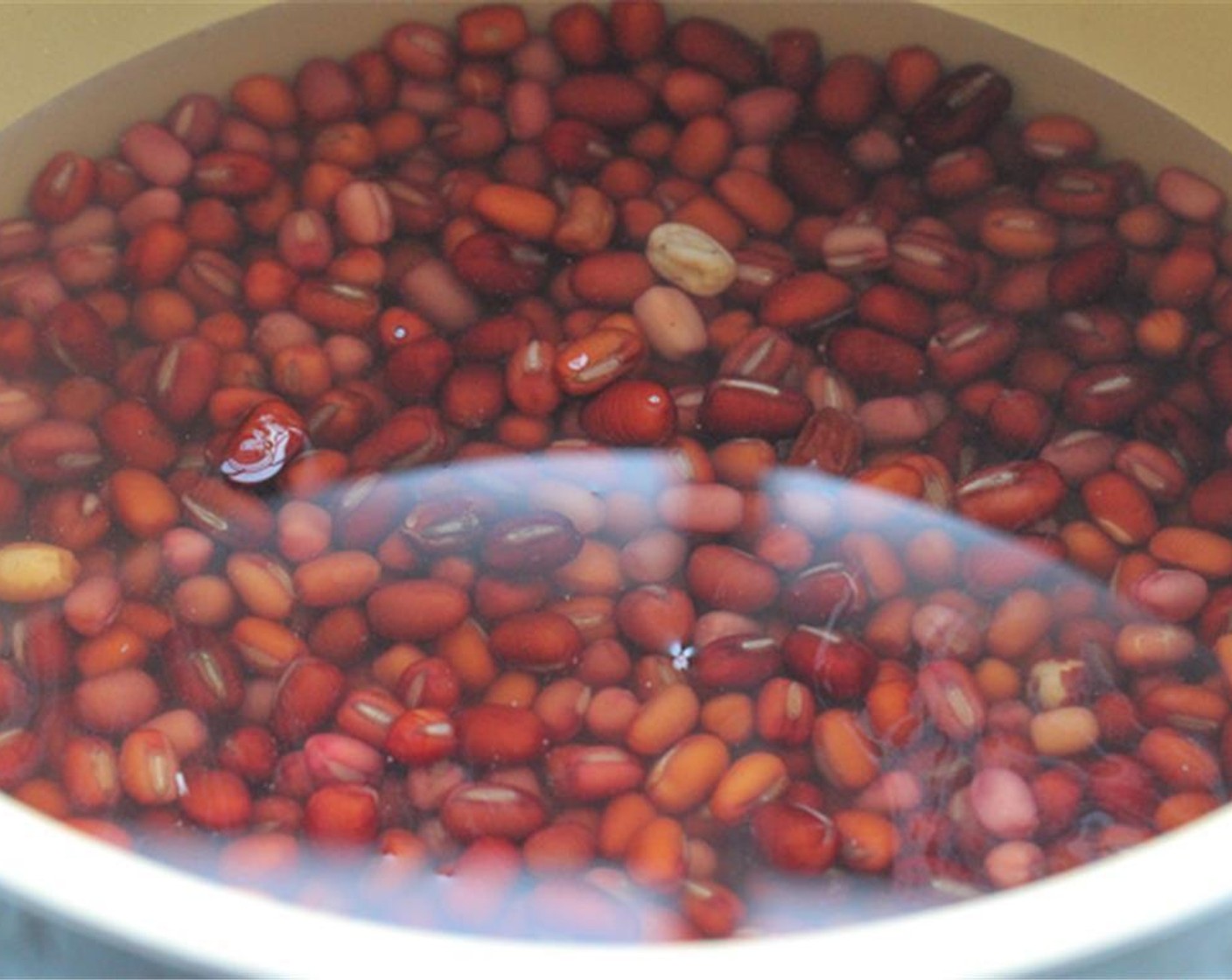 step 2 Remove the beans that float to the surface. Add Water (3 cups) and beans to a pressure cooker. The water should cover the beans. Bring the mixture to a boil then lower the heat to a gentle simmer.