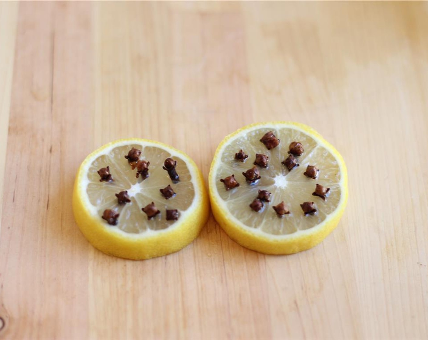 step 1 Slice Lemon (1) and stud with Whole Cloves (to taste).