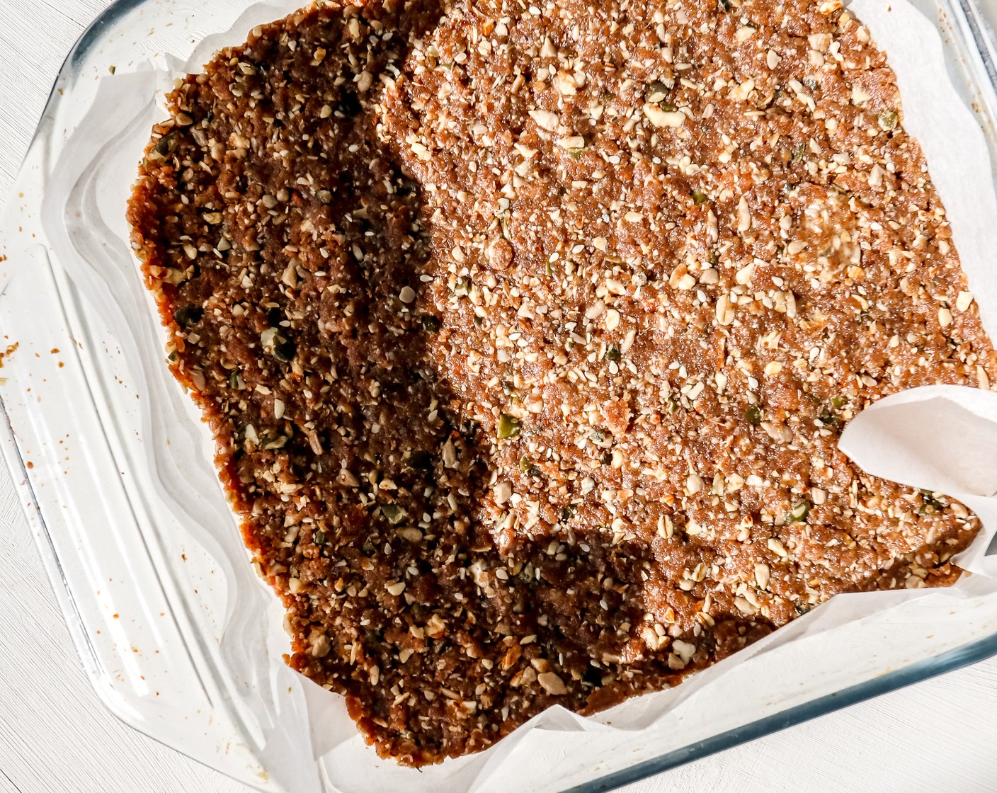 step 5 Line a small, square baking dish with baking paper. Spoon the mixture into it, then use your hands to flatten it out and smooth over the top.