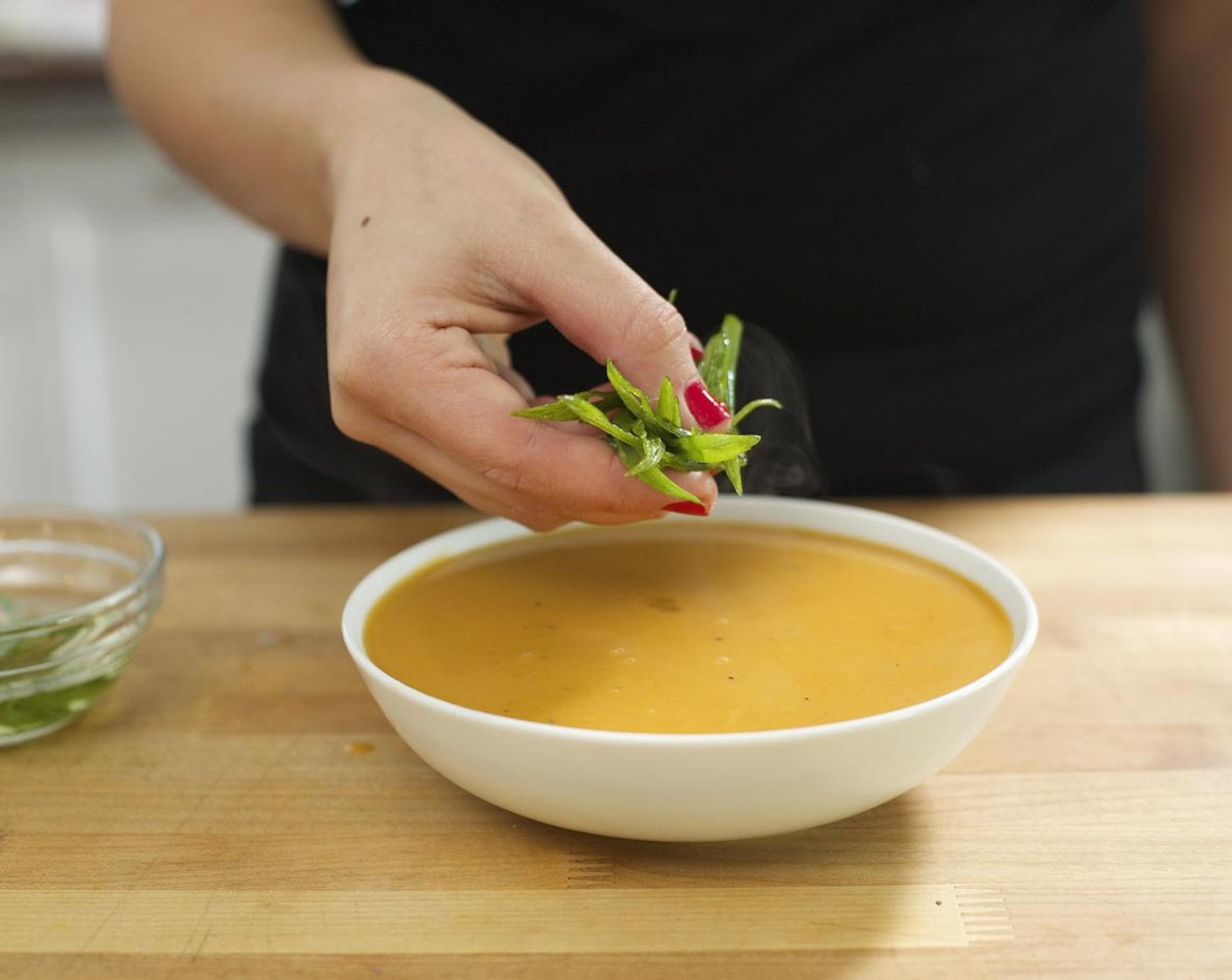 step 7 Ladle the soup into two bowls. Top with green onions and Pepitas (2 Tbsp).