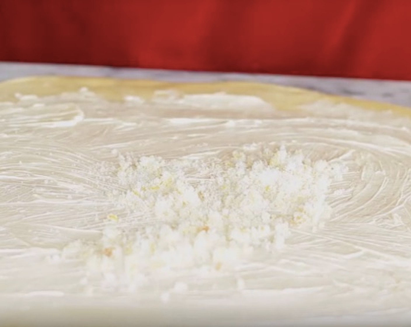 step 9 Using a spoon, spread Butter (4 Tbsp) evenly across dough. Sprinkle the sugar, lemon and vanilla mixture on top.
