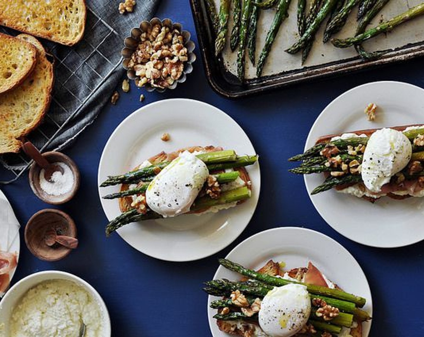 step 14 Sprinkle with Walnut (1/2 cup). Top with a poached egg on each sandwich half. Drizzle with extra-virgin olive oil and season lightly with salt and freshly cracked black pepper.