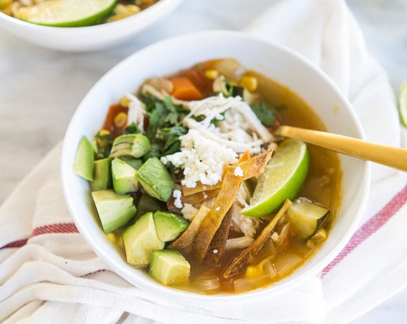 step 6 Divide shredded chicken between bowls. Ladle soup over chicken, and top with Avocados (2), Tortilla Chips (to taste), Fresh Cilantro (to taste), and Queso Fresco (1 cup).