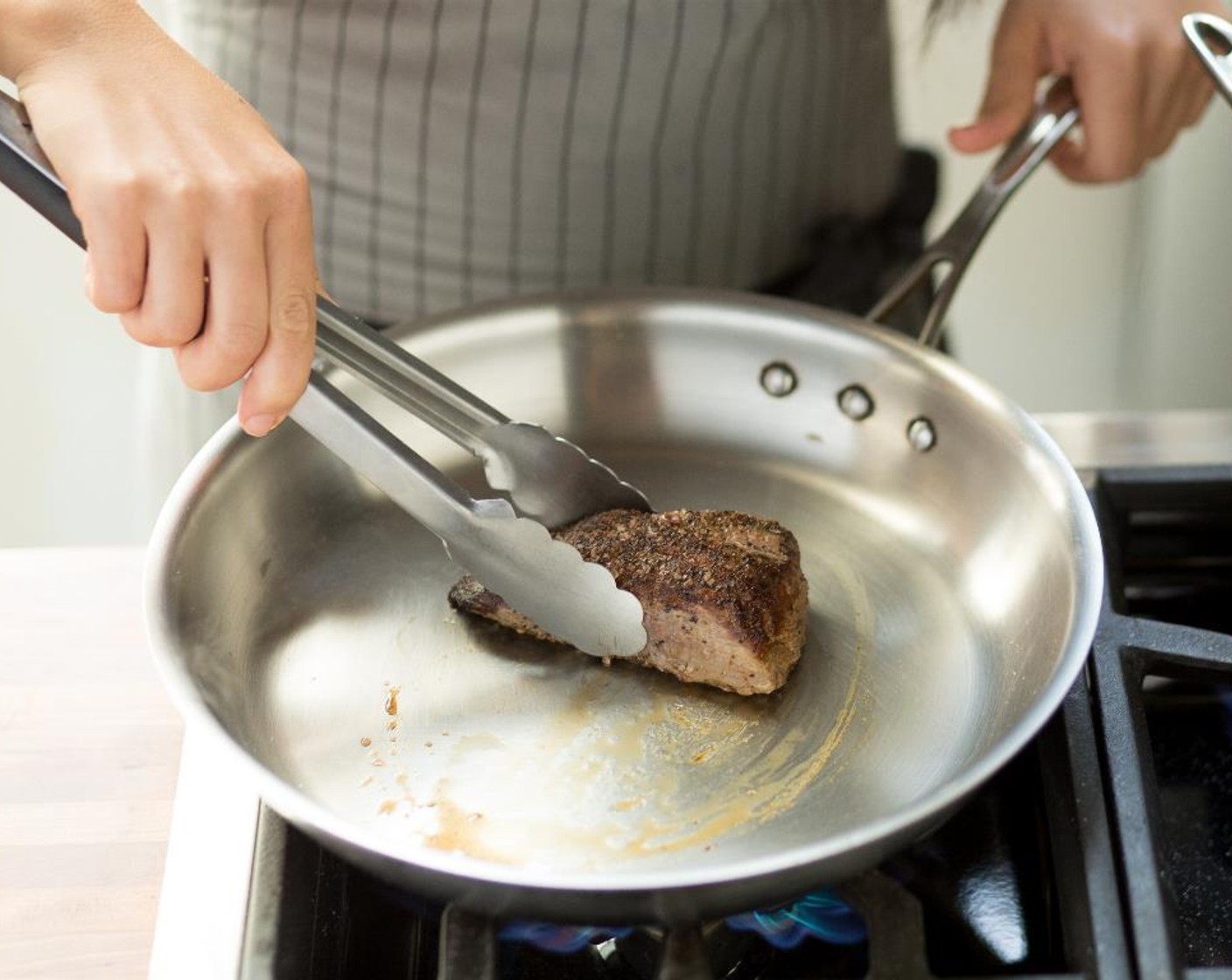 step 6 When hot, add the beef tenderloins and sear on both sides for 5 minutes.