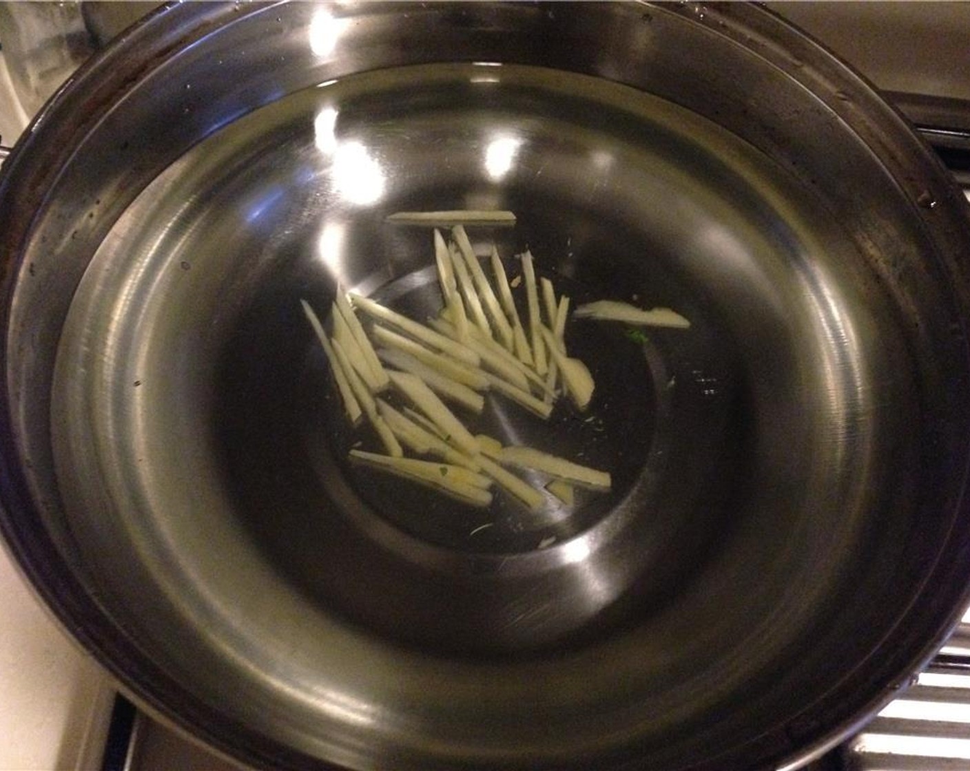 step 7 In a pot, add Water (4 cups) and the sliced ginger. Bring to a boil.