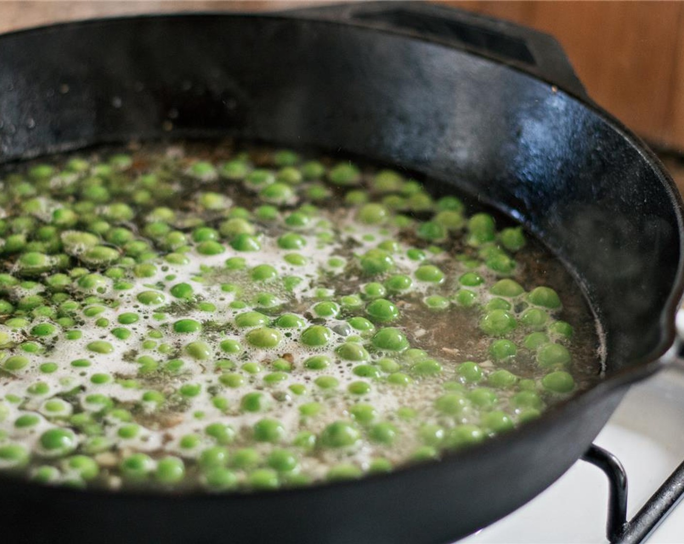 step 9 Add the peas and 1 cup of the pasta water. Simmer for 2 minutes if the peas are fresh.