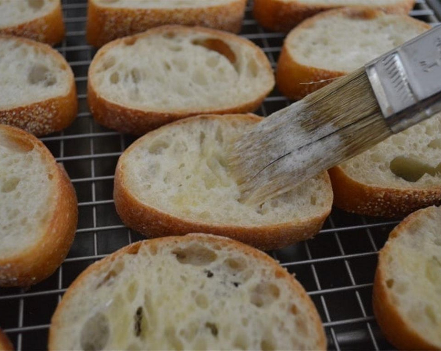 step 3 Transfer the slices of bread to a baking sheet fitted with a rack and brush each one generously with the Butter (1/4 cup).