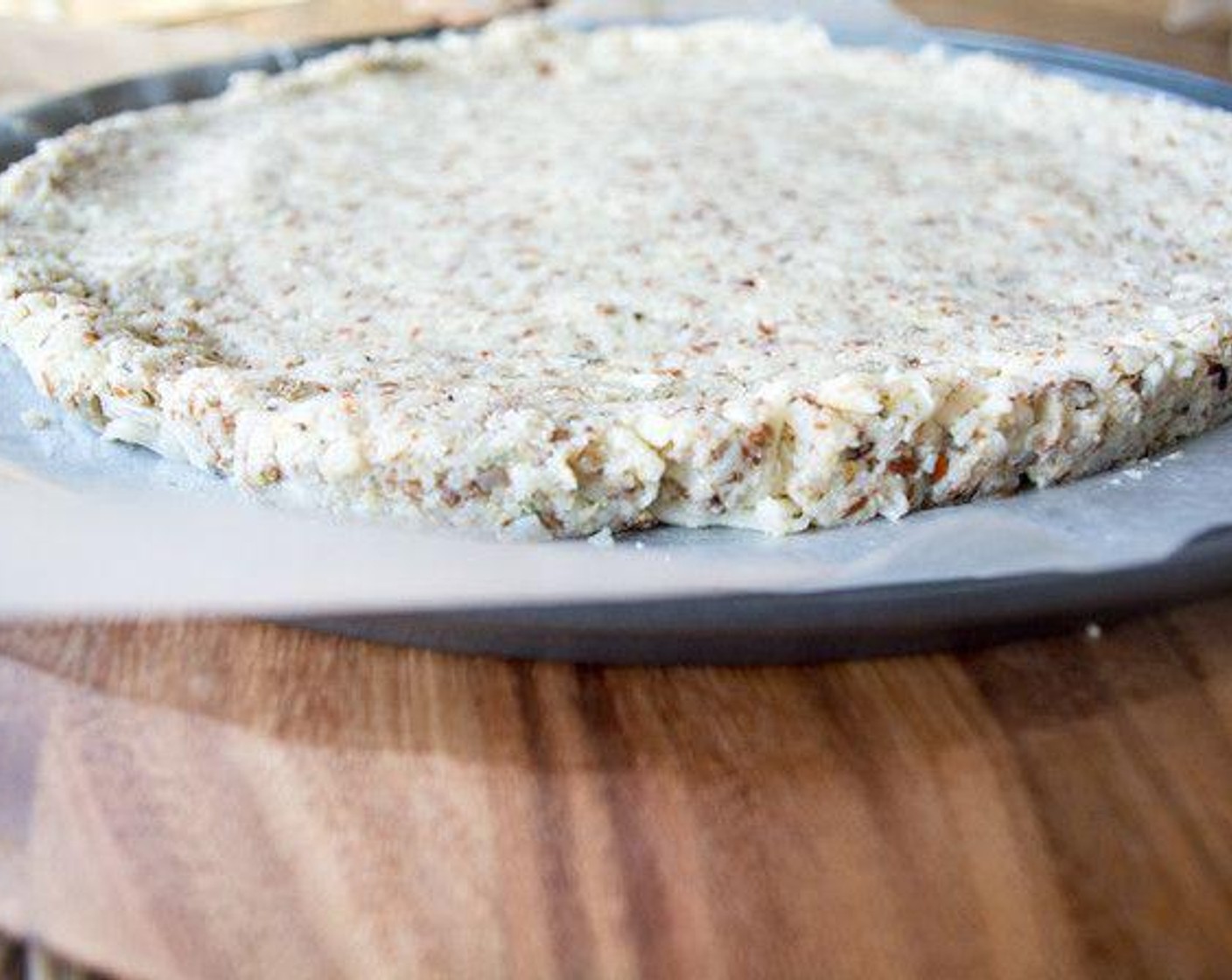 step 6 Transfer to greased pizza pan and spread out, using a spatula, to an even round crust.