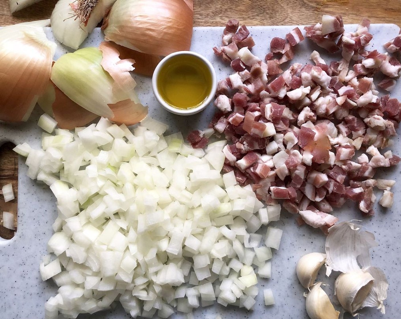 step 3 Meanwhile, heat the Extra-Virgin Olive Oil (2 Tbsp) in a medium (10-inch) stockpot or Dutch oven over medium heat. Add the Pancetta (3/4 cup) and Onion (1) and saute over medium to medium-high heat for 12 to 18 minutes, until browned.