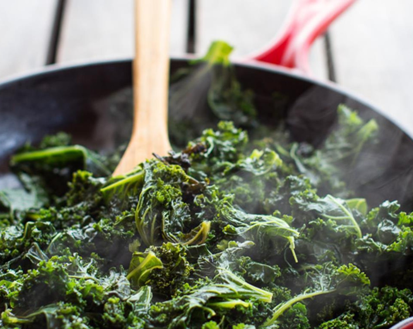step 2 Heat a very large skillet (the largest you have!) over medium-high heat. Add all of the Kale (2 bunches) to the skillet and add 1 cup of water. Cover the skillet and cook for 10-15 minutes, stirring occasionally until the kale is wilted.