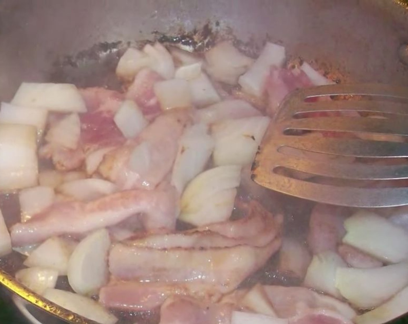 step 3 Once the meat is browned, add Bacon (6 slices) and Onion (1) and brown briefly. Slowly add some hot water and gently stir to loosen browned bits at bottom of pan.