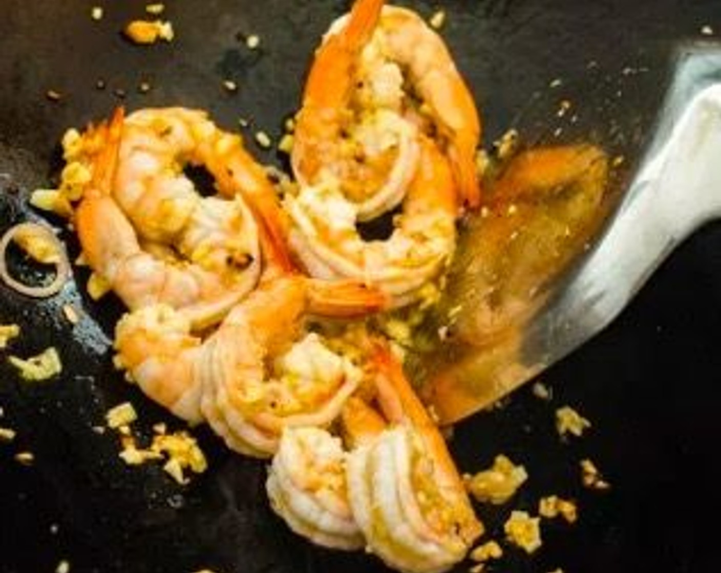 step 5 Add Garlic (2 cloves) to the wok, followed by the Medium Shrimp (8). Stir-fry for about 30 seconds or until the shrimp are halfway cooked.