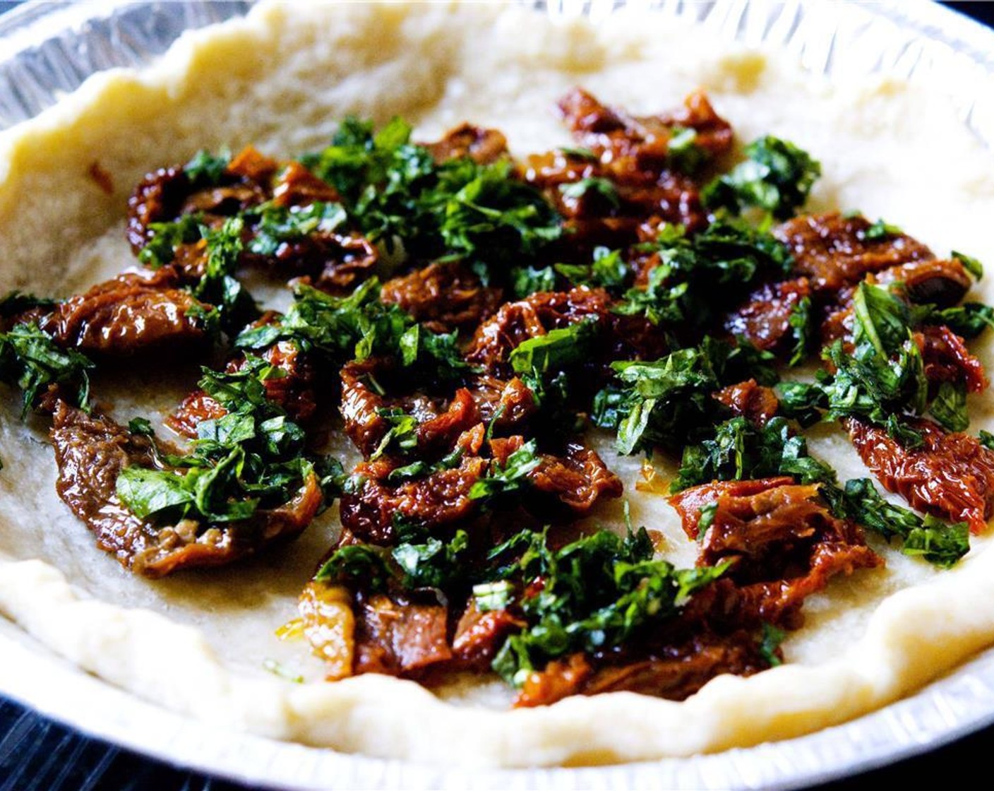 step 6 Add both the Sun-Dried Tomatoes (1/3 cup) and fresh basil leaves to the pie.