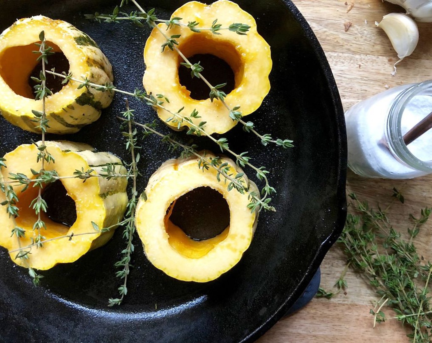 step 5 Wipe the skillet. Add the remaining Olive Oil (1 Tbsp).  Add the squash rings, turning to coat all sides with oil.  Sprinkle with 1/4 teaspoon of Salt (to taste) and toss in the Fresh Thyme (4 sprigs). Bake for 15 minutes and flip the squash over.