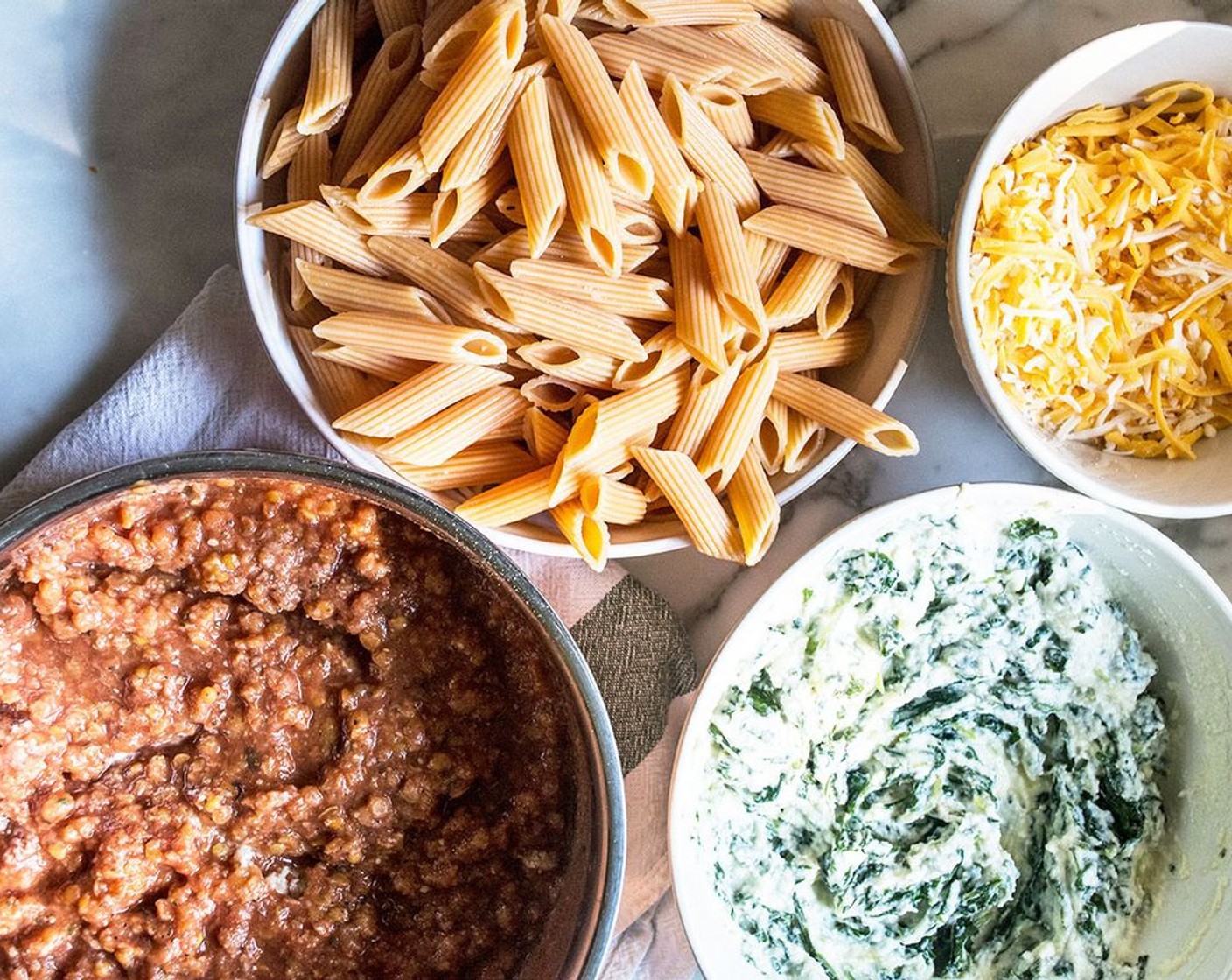 step 5 In a 2 qt dish, layer half red lentil pasta, ricotta cheese mixture, seasoned tomato lentils, and Shredded Italian Blend Cheese (1 1/4 cups), then repeat, ending with Italian Cheese.