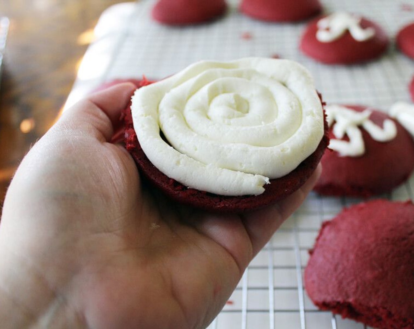 step 8 Spoon the frosting into a decorating bag. Snip the end off, and swirl a layer of icing on the inside of a cake. Place another cake on top