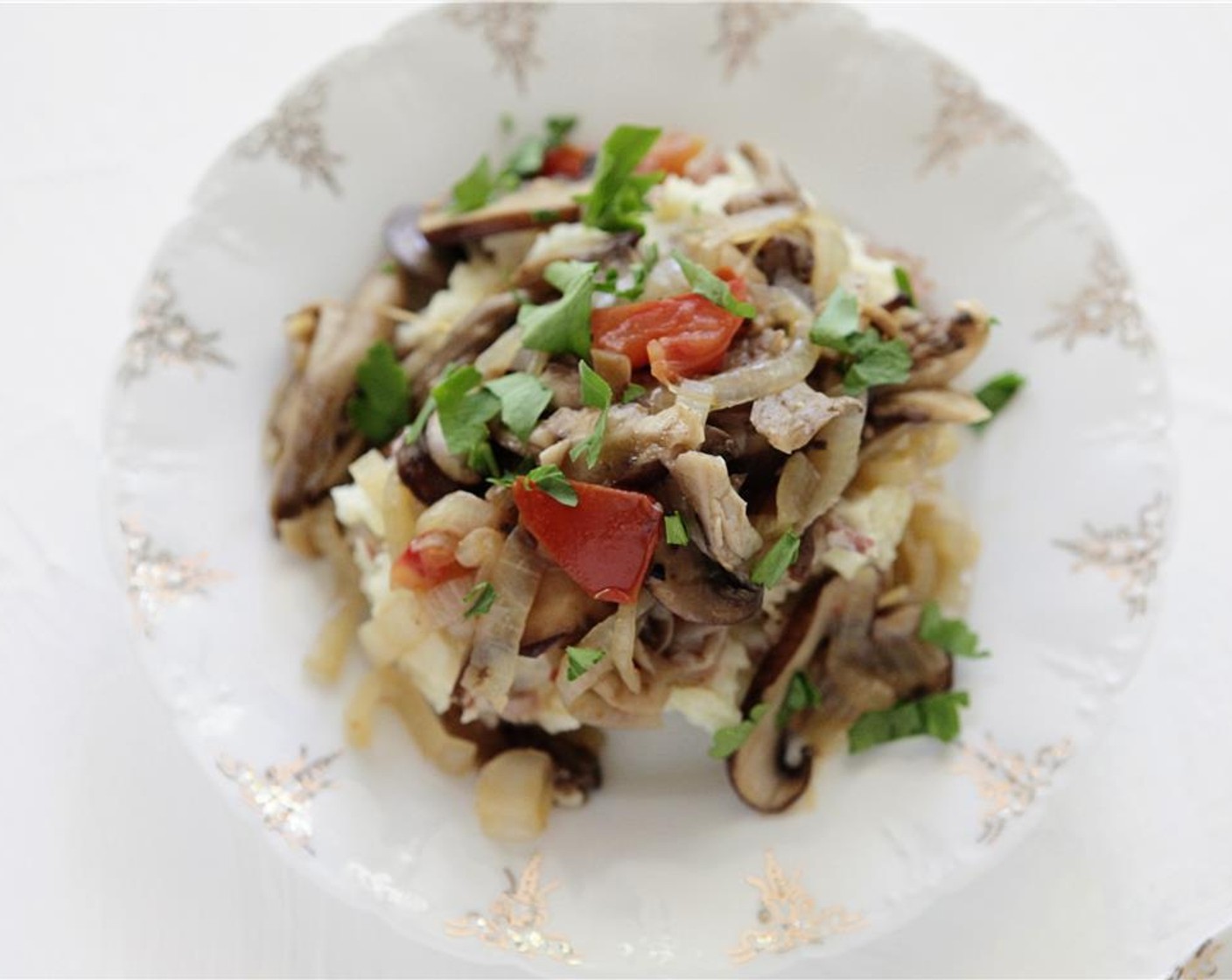 step 6 When the mushrooms have cooked, remove from heat, and season to taste with Kosher Salt (to taste) and Ground Black Pepper (to taste). Add italian parsley. Divide the potatoes onto two plates, top with the fricasse of mushrooms. Serve and enjoy!