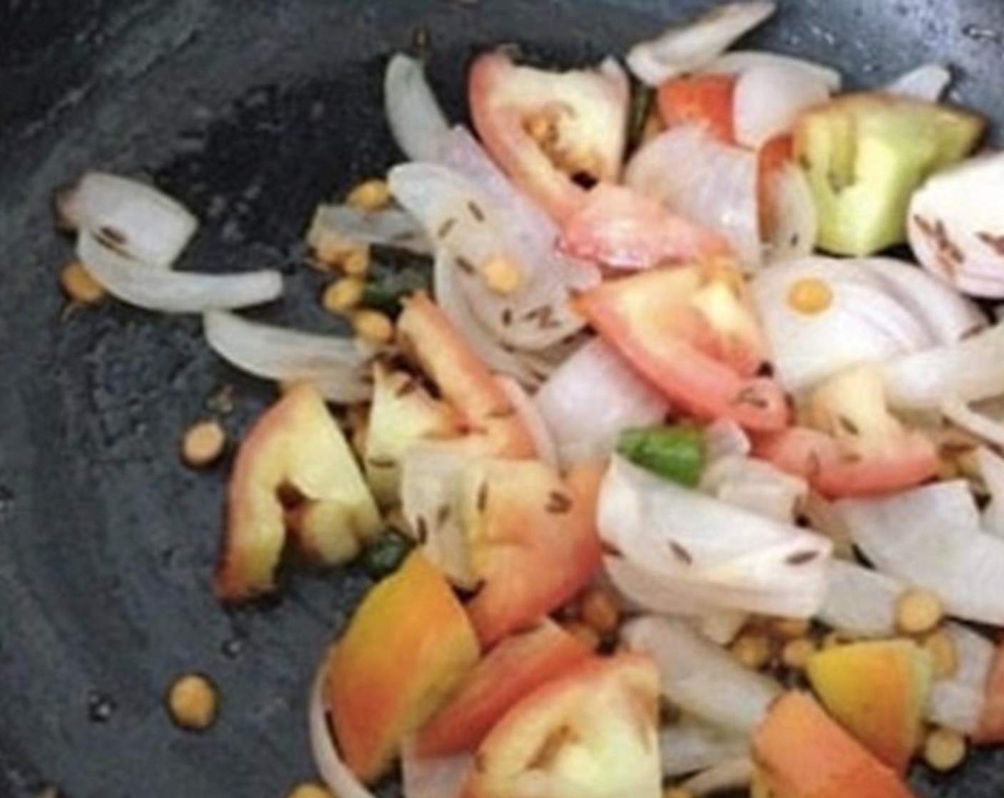 step 2 Add Dried Red Chili Peppers (2), Onion (1), and Tomato (1). Add Salt (to taste) and cook for 5 minutes.