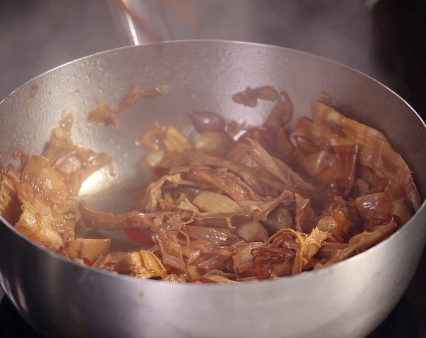 step 1 Put Cooking Oil (2 Tbsp), Granulated Sugar (1 Tbsp), Onions (5) and Chili Pepper (1) into a hot pot, then add dried Bamboo Shoots (1 cup).