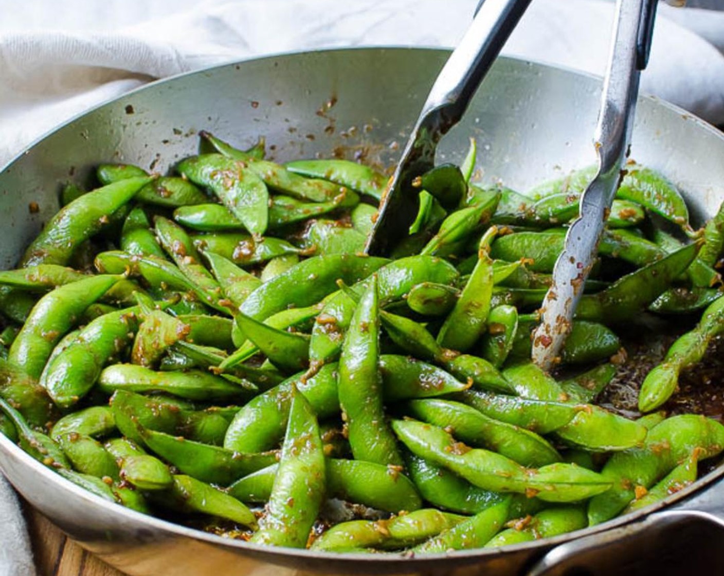 step 6 Carefully add the package of frozen edamame in pods, Edamame (4 1/2 cups) and don't stir -- allow it to sear and blister about 1-2 minutes.