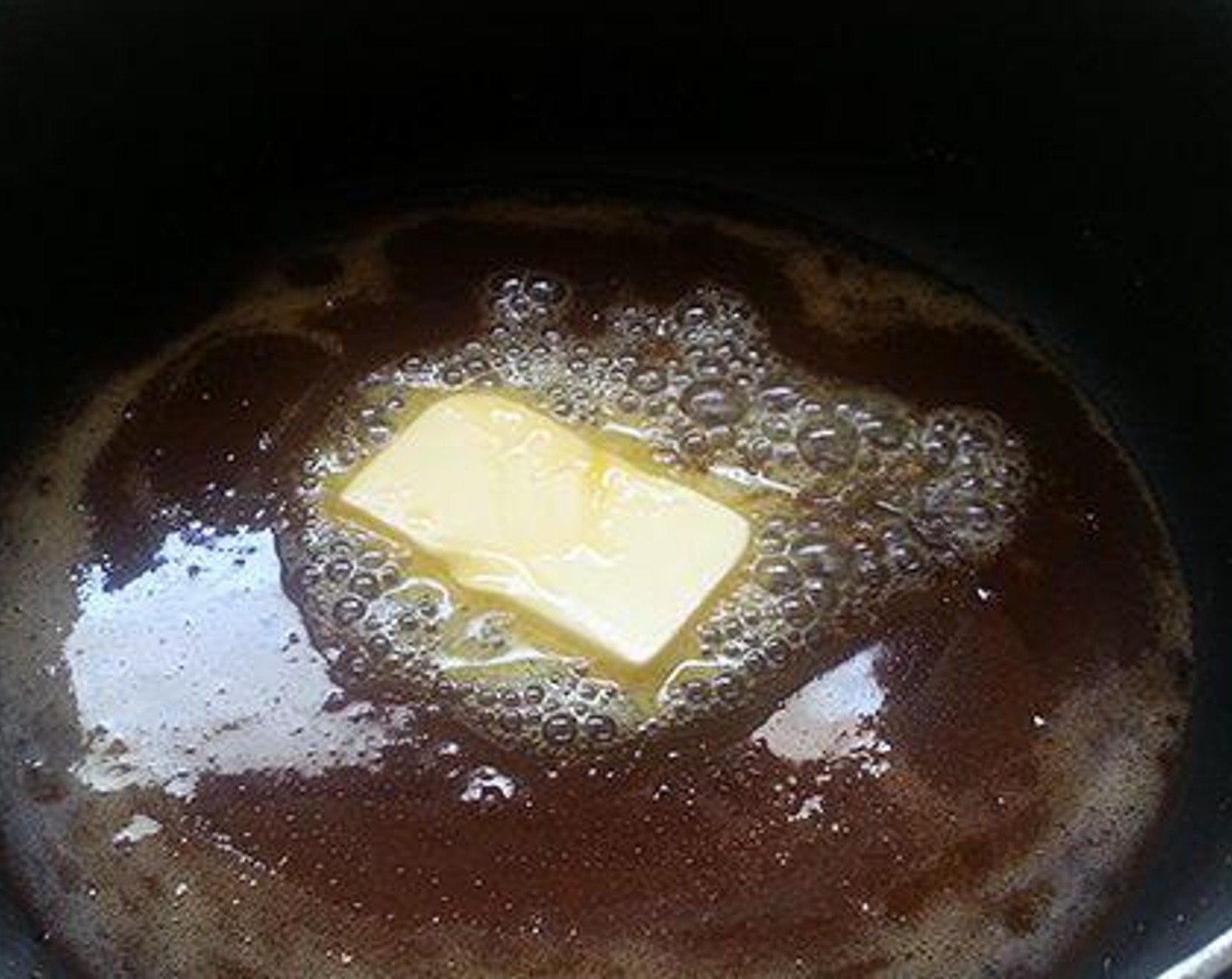 step 2 To a heavy bottom pan add Caster Sugar (180 g) and let it caramelize. Once it becomes light brown in color switch off the flame and add Butter (1 Tbsp) and mix well