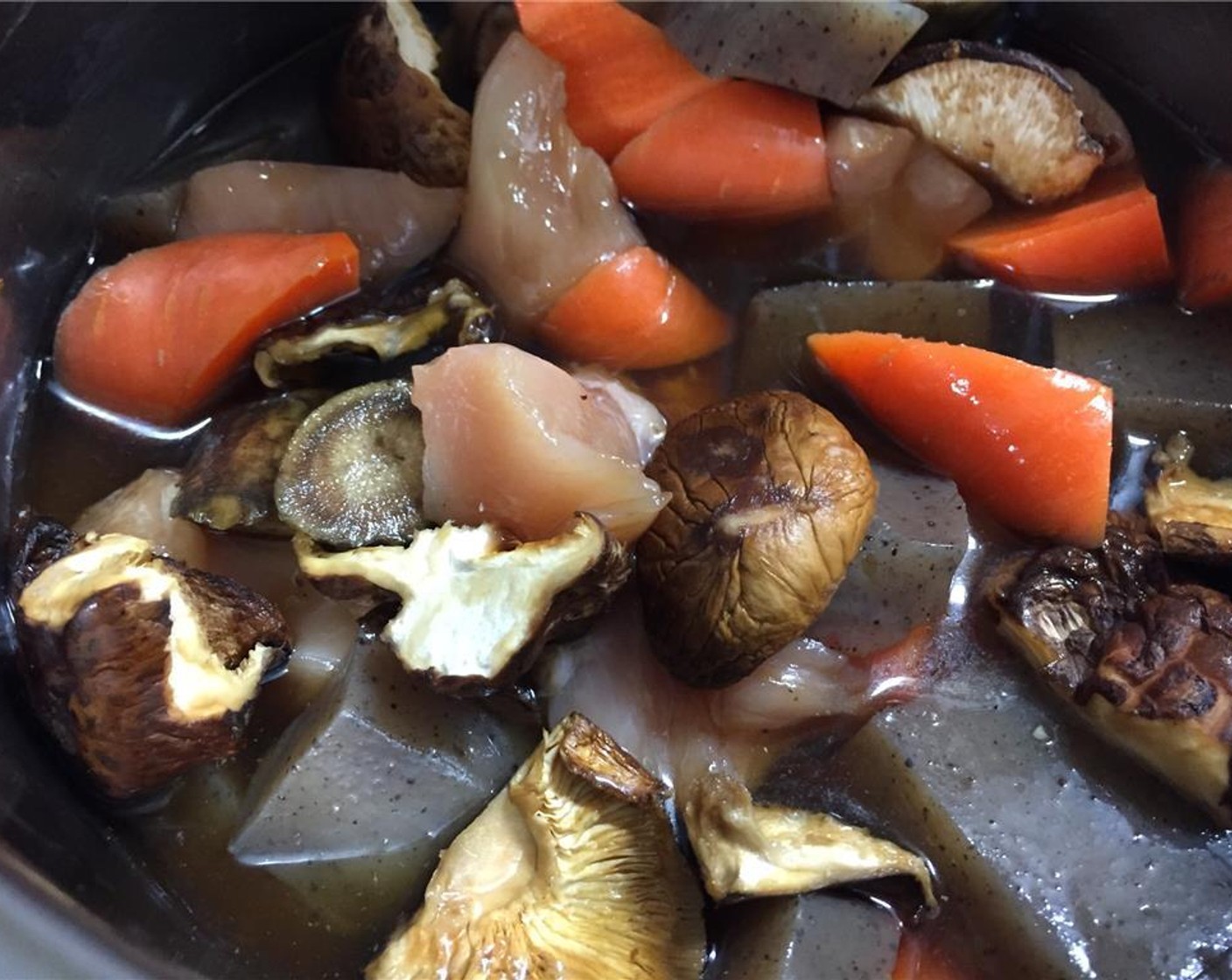 step 9 Add the chicken, carrot, ginger, and konnyaku and stir, then pour in the water, soy-sauce, and sugar mixture.