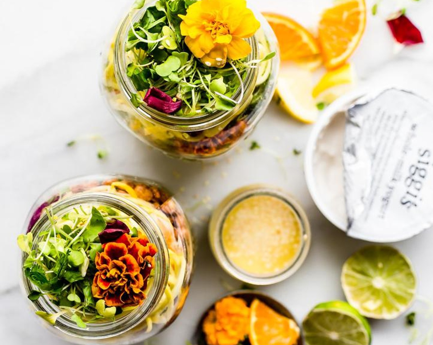 step 3 For the salads, layer half the amount into each jar. Start with the dressing on the bottom, then Quinoa (1 cup), Salad Greens (1 cup), Oranges (3 slices), Canned Chickpeas (1/3 cup), Brussels Sprouts (1 cup), and Summer Squash.