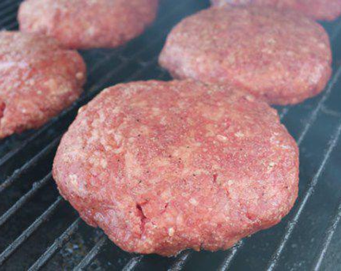 step 6 Place burgers on cooking grate and smoke for 30 minutes.