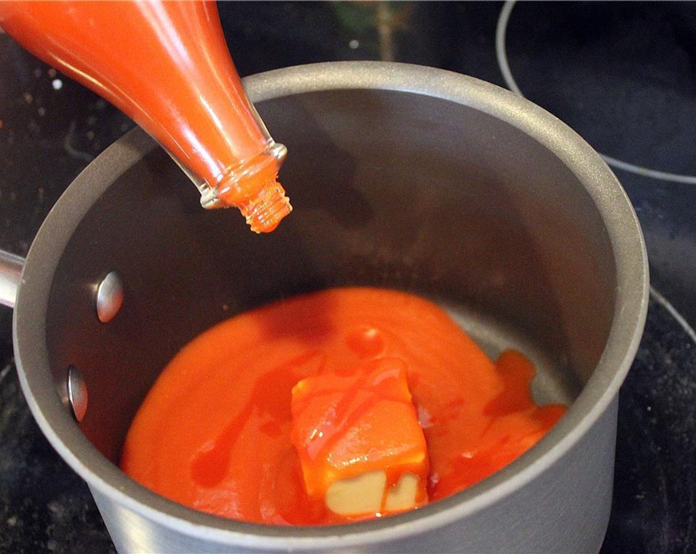 step 1 In a small pan, add Tomato Sauce (1 cup), Unsalted Butter (3 Tbsp) and Hot Sauce (1/4 cup). Mix and melt the unsalted butter over medium heat. Turn the burner off once the butter has melted.