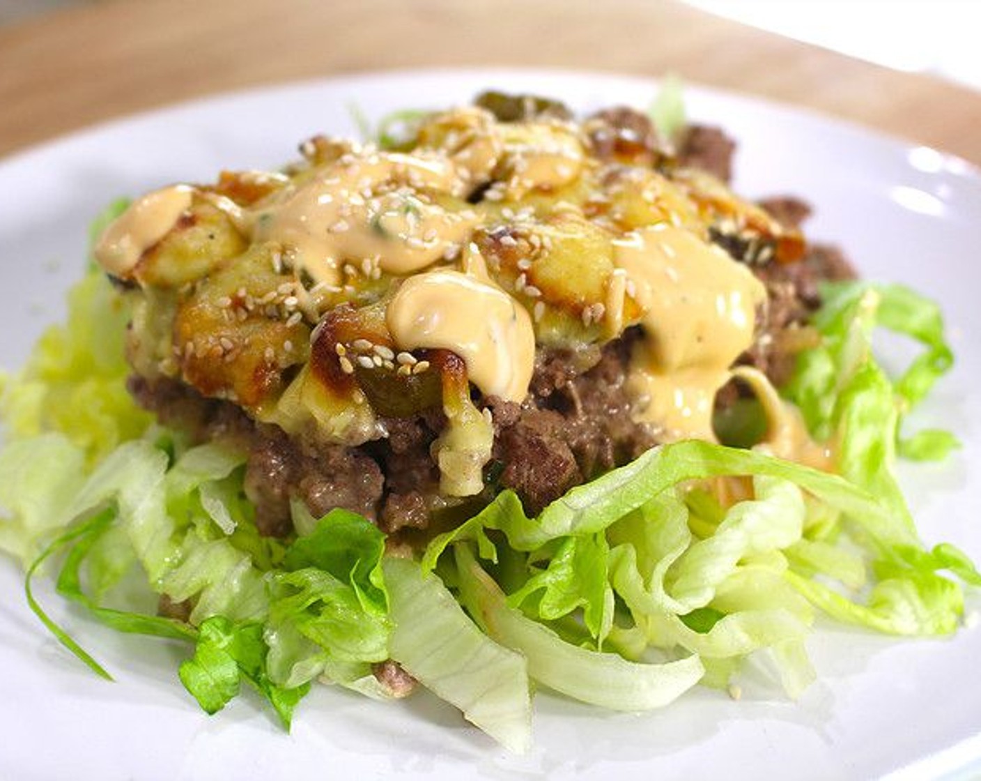 step 7 Plate each serving on top of a bed of Lettuce (1 head) and top with remaining Big Mac sauce.